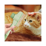 Green comb close-up on cat